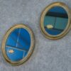 Paire de miroirs ovales vintage 1950's